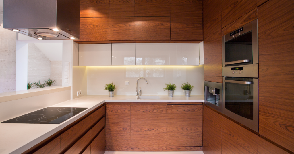 Custom all-wood kitchen cabinets with navy blue base units and white upper cabinets featuring soft-close drawers. Kitchen Cabinets.